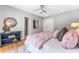 Bedroom featuring light gray walls, wood flooring, a ceiling fan, and stylish decor at 3125 W Fielder St, Tampa, FL 33611