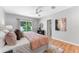 Bright bedroom featuring wood floors, a ceiling fan, and sliding doors to the backyard at 3125 W Fielder St, Tampa, FL 33611