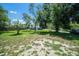 Spacious fenced backyard with mature trees, offering privacy and space for outdoor activities at 3305 Blythe Ave, Spring Hill, FL 34609