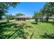 Fenced backyard with mature trees, shed, and plenty of space for outdoor activities at 3305 Blythe Ave, Spring Hill, FL 34609