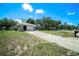 Quaint single-story home featuring an attached garage and expansive driveway at 3305 Blythe Ave, Spring Hill, FL 34609