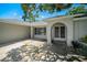 Covered front entrance with arched doorway, sidelight window, and tidy landscaping at 3305 Blythe Ave, Spring Hill, FL 34609