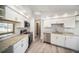 Modern kitchen features granite countertops, stainless steel appliances, and white cabinetry at 3305 Blythe Ave, Spring Hill, FL 34609