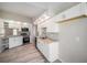 Bright kitchen with white cabinets, stainless appliances, and updated granite countertops at 3305 Blythe Ave, Spring Hill, FL 34609