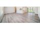 Bright and airy living room featuring laminate flooring and a clear view of the kitchen at 3305 Blythe Ave, Spring Hill, FL 34609