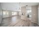Inviting living room featuring updated laminate flooring, natural light, and white trim at 3305 Blythe Ave, Spring Hill, FL 34609