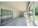 Enclosed patio with sliding glass doors that open to the backyard, perfect for relaxing or entertaining at 3305 Blythe Ave, Spring Hill, FL 34609