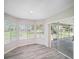 Bright sun room features lots of windows and sliding glass doors to an outdoor patio at 3305 Blythe Ave, Spring Hill, FL 34609