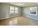 Neutral bedroom with tile flooring and natural light from two windows, offers a comfortable and versatile space at 4214 Fairfield S Ave, St Petersburg, FL 33711