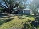 Inviting single-story home featuring a simple, landscaped front yard with mature trees and a walkway at 4214 Fairfield S Ave, St Petersburg, FL 33711