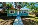 Inviting single-story home with walkway, complemented by lush greenery at 4214 Fairfield S Ave, St Petersburg, FL 33711