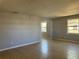 Open-concept living area with neutral walls, tile floors, and arched doorway at 4214 Fairfield S Ave, St Petersburg, FL 33711