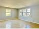 Spacious living room featuring tile floors, neutral walls and large windows at 4214 Fairfield S Ave, St Petersburg, FL 33711