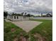 Grassy backyard with a concrete patio, lush grass, and a pristine white fence at 4434 Bass St, Tampa, FL 33617