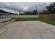 Spacious backyard featuring a concrete slab, a grassy area, and a white privacy fence at 4434 Bass St, Tampa, FL 33617