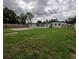 Backyard featuring a well-maintained lawn, a concrete patio, and mature trees at 4434 Bass St, Tampa, FL 33617