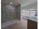 Modern bathroom featuring new shower with tile surround, new vanity, and updated fixtures at 4434 Bass St, Tampa, FL 33617
