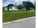 Landscaped front yard showcasing a charming single-story home with a well-maintained lawn at 4434 Bass St, Tampa, FL 33617