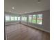 Bright living room featuring new floors and many windows that provide an abundance of natural light at 4434 Bass St, Tampa, FL 33617