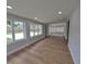 Bright living room featuring new floors and many windows that provide an abundance of natural light at 4434 Bass St, Tampa, FL 33617