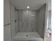Modern shower featuring tile walls and a brushed gold shower head at 4434 Bass St, Tampa, FL 33617