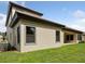 A view of the rear exterior of the home featuring a covered patio and the lawn at 4523 Foley Grove Dr, Valrico, FL 33596