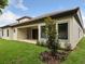 Expansive backyard with covered patio and a lush lawn, perfect for outdoor entertaining and relaxation at 4523 Foley Grove Dr, Valrico, FL 33596