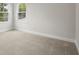 Bright and airy bedroom with two windows, neutral walls and soft, plush carpeting at 4523 Foley Grove Dr, Valrico, FL 33596