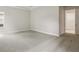 A cozy bedroom with neutral walls and carpet, white trim and an ensuite bathroom at 4523 Foley Grove Dr, Valrico, FL 33596