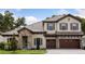Charming two-story home with stone accents, a well-manicured lawn and a spacious two car garage at 4523 Foley Grove Dr, Valrico, FL 33596