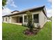 Home exterior with a large backyard, covered patio, lush lawn, and manicured landscaping at 4523 Foley Grove Dr, Valrico, FL 33596