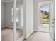 Bright and airy foyer with hardwood floors, glass panel doors, and a view of the front yard at 4523 Foley Grove Dr, Valrico, FL 33596