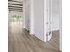 Hallway featuring wood floors, beamed ceilings, and a seamless transition to the living area at 4523 Foley Grove Dr, Valrico, FL 33596