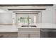 Close up of this white countertop stainless sink in this kitchen, featuring wooden beams at 4523 Foley Grove Dr, Valrico, FL 33596
