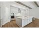 Bright, white kitchen with stainless steel appliances, granite countertops, and wooden beams at 4523 Foley Grove Dr, Valrico, FL 33596
