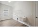 Laundry room with utility sink, window, and storage shelf at 4523 Foley Grove Dr, Valrico, FL 33596