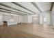 Open-concept living area with hardwood floors, beamed ceilings, seamlessly connecting the kitchen and living space at 4523 Foley Grove Dr, Valrico, FL 33596