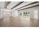 Spacious living room with wooden beams, lots of light, and sliding glass doors to the backyard at 4523 Foley Grove Dr, Valrico, FL 33596