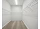 Walk-in closet with carpet flooring and metal shelving for storage and organization at 4523 Foley Grove Dr, Valrico, FL 33596