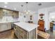 Updated kitchen with a center island, mosaic tile backsplash, and seamless flow into the adjacent dining and living areas at 4651 1St Ne St # 402, St Petersburg, FL 33703