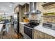 Modern kitchen featuring stainless steel appliances, stylish tile backsplash, and a view into the dining area at 4651 1St Ne St # 402, St Petersburg, FL 33703