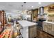 Open-concept kitchen with island seating flows into the dining and living areas, creating a cohesive space at 4651 1St Ne St # 402, St Petersburg, FL 33703