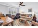 Cozy living room with large window, comfortable seating, and ceiling fan at 4651 1St Ne St # 402, St Petersburg, FL 33703