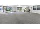 Welcoming lobby with neutral carpet, bright windows, and plants offers a warm greeting to residents and guests at 4651 1St Ne St # 402, St Petersburg, FL 33703