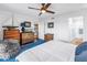 Bright main bedroom featuring light walls, a ceiling fan, and an ensuite bathroom at 4651 1St Ne St # 402, St Petersburg, FL 33703