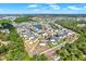 Stunning aerial view of a residential neighborhood boasting lush greenery and tranquil ponds at 5067 Sable Chime Dr, Wimauma, FL 33598