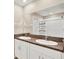 Bathroom featuring a double vanity with granite counters and a large mirror at 5067 Sable Chime Dr, Wimauma, FL 33598