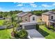 Two-story home with a gray roof, neutral-toned stucco, and a two-car garage at 5067 Sable Chime Dr, Wimauma, FL 33598