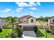 Two-story home featuring a gray roof, neutral-toned stucco, and a two-car garage at 5067 Sable Chime Dr, Wimauma, FL 33598