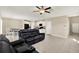 Open concept living space with tile floors, ceiling fan, and white cabinets in the kitchen at 5067 Sable Chime Dr, Wimauma, FL 33598